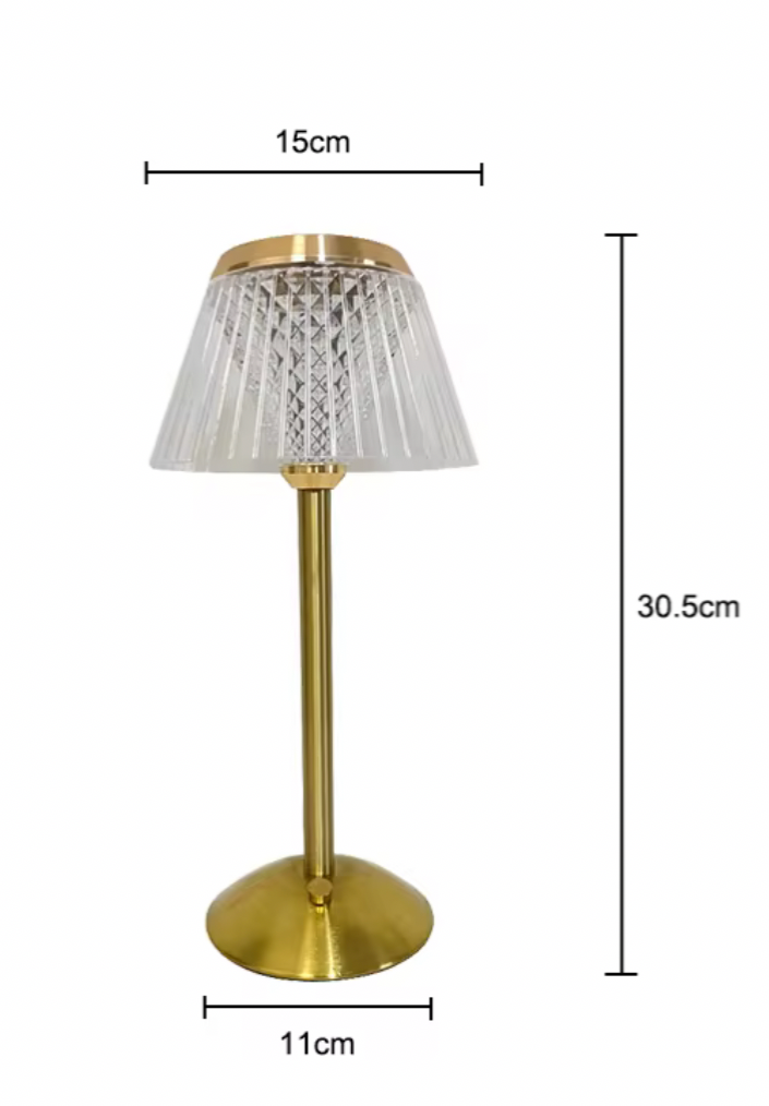 Gold table lamp with measurements on a white background
